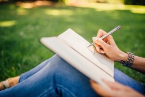 Woman writes in journal - Holiday Scripts
